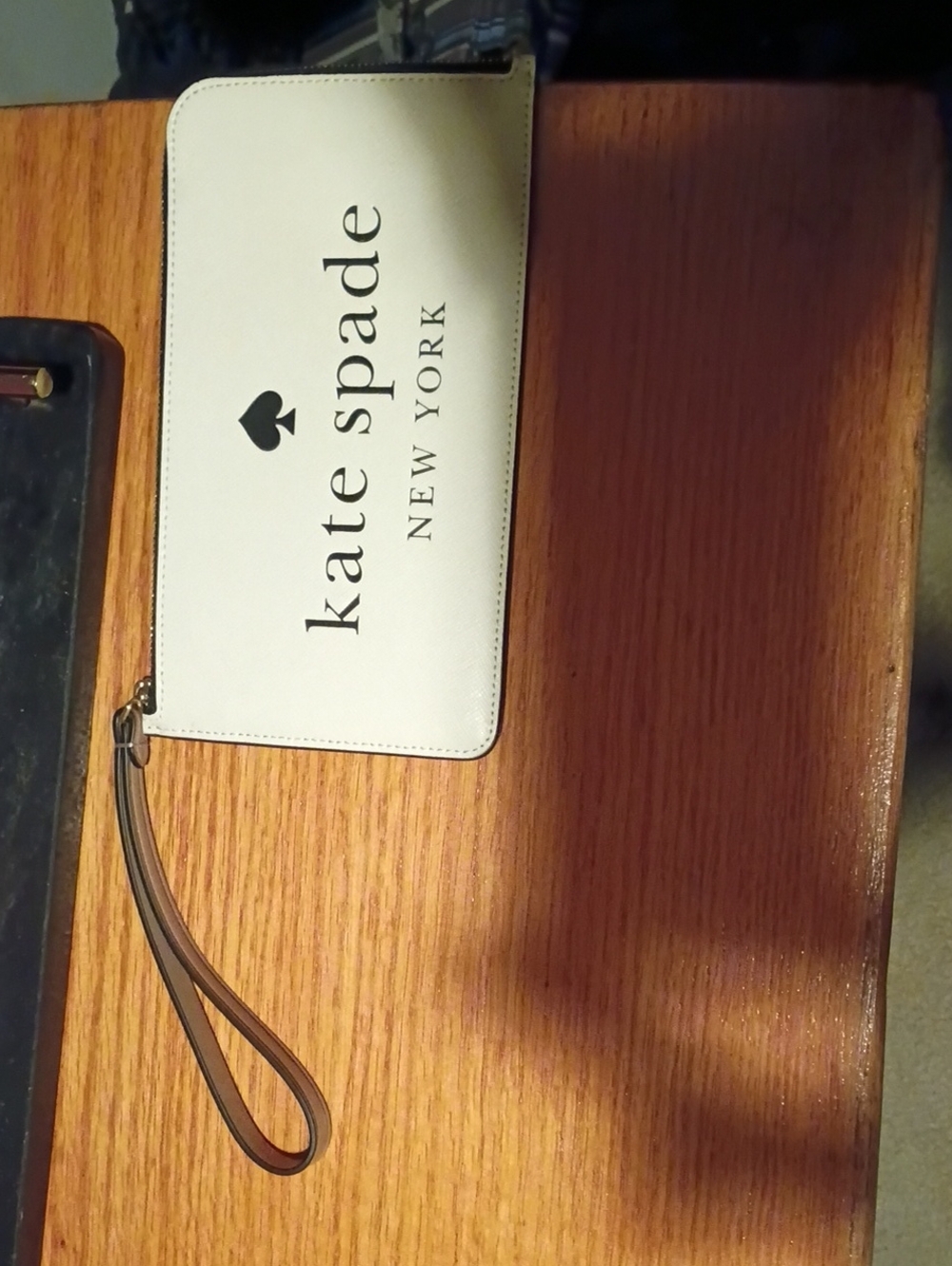 kate spade white and tan logo zip wristlet